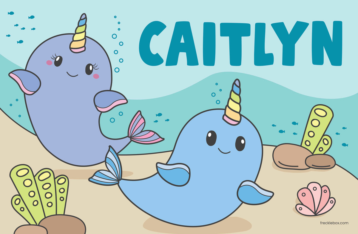 Personalized placemat with child&#39;s name and 2 cute Narwhals in the sea.